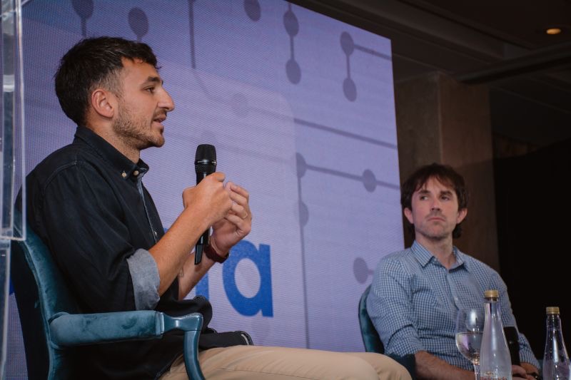 Matias Venutolo speaking with a microphone during a panel at ADRHA